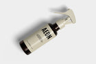 Single AEON ceramic coating bottle floating at dynamic angle showing cream and amber design