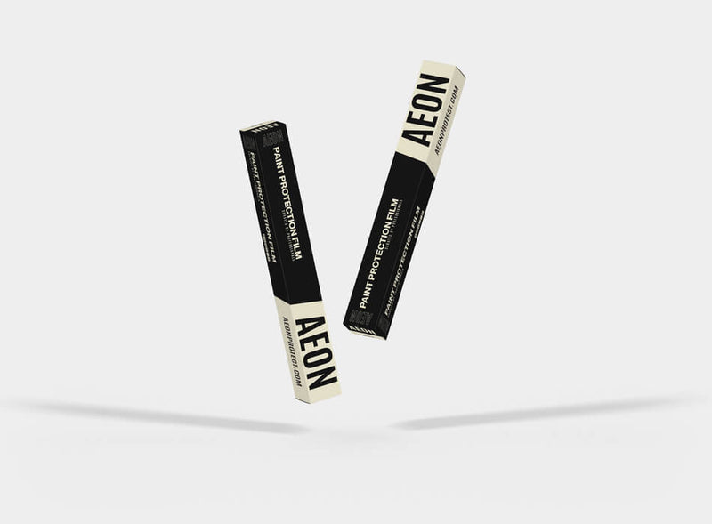 Two black and cream AEON protection film boxes displayed at an angle